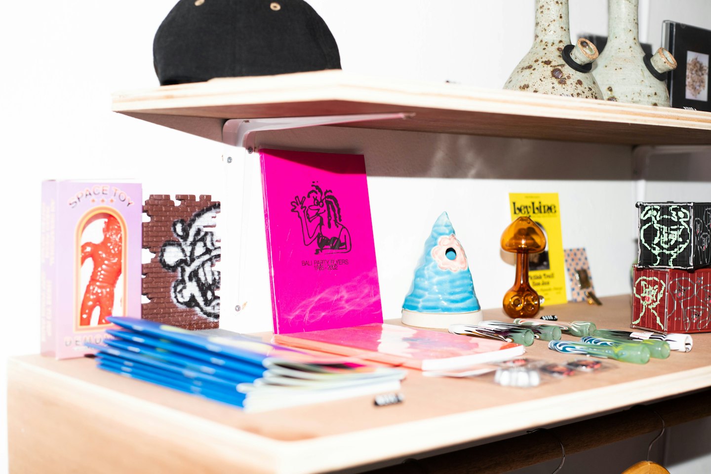 Wooden shelves displaying quirky toys, stationery, and decorative home items.